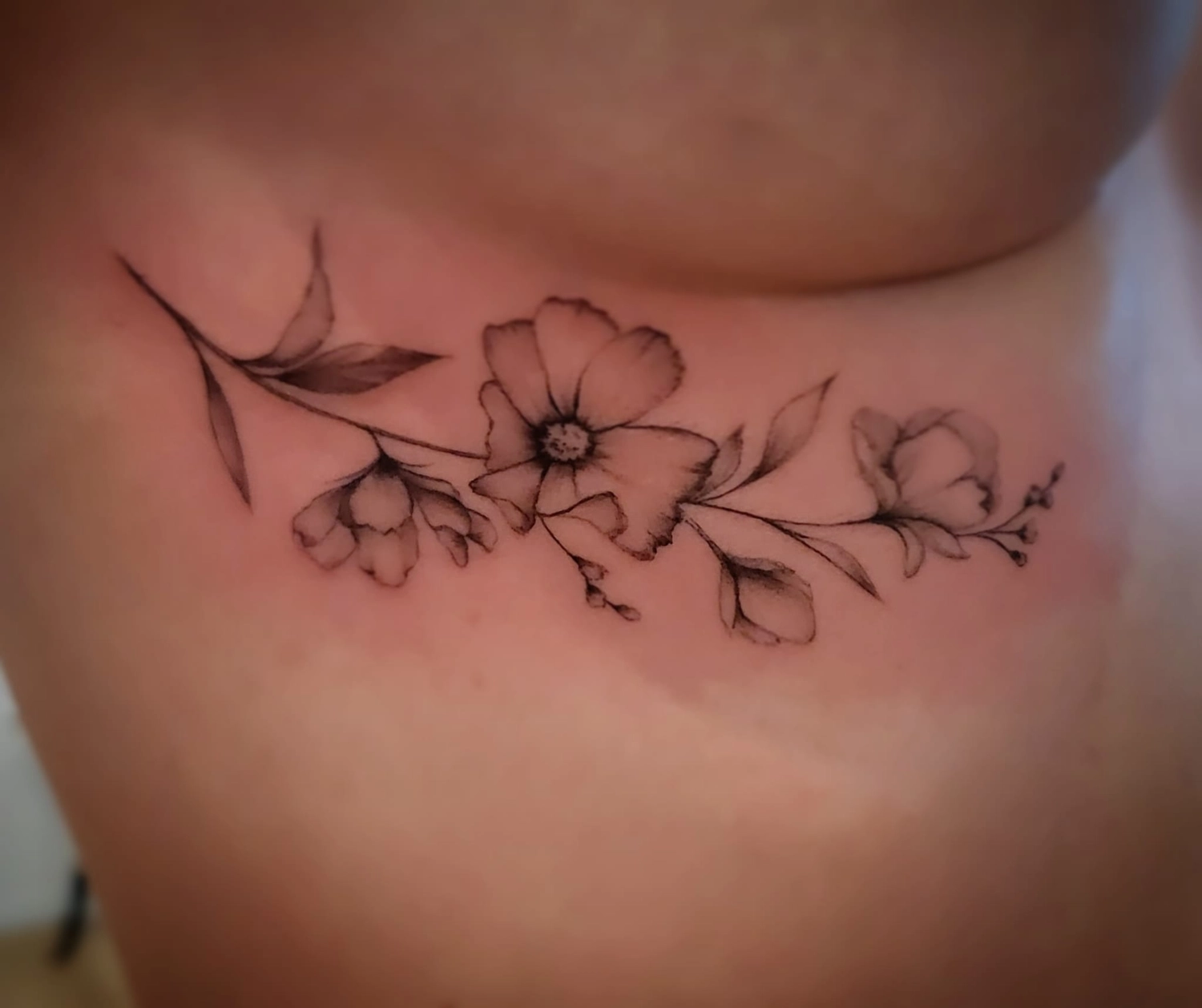 A Fleur de Peau - Professionelles Tattoo Studio - Tätowierung am Hals einer Person